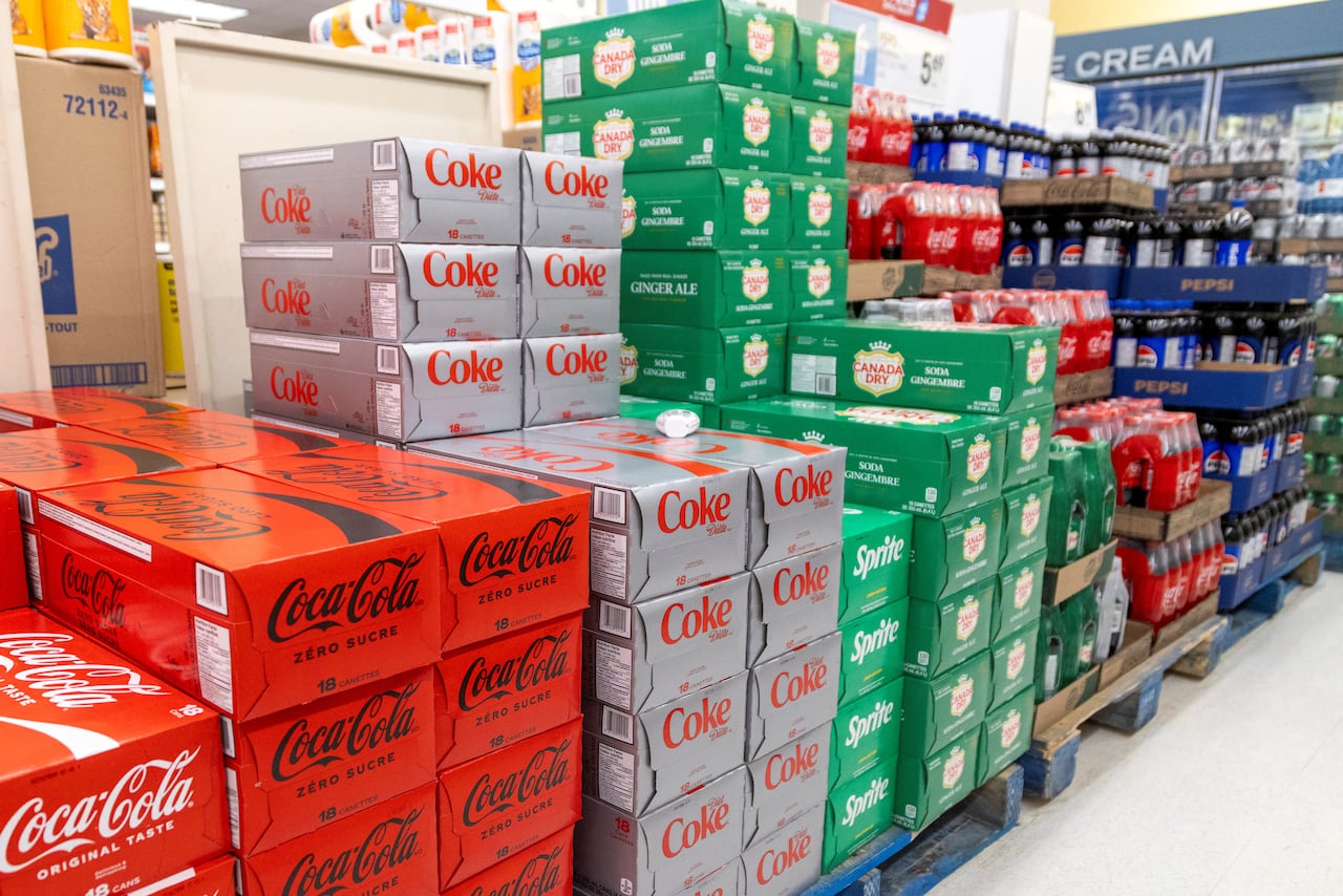 Stacks of soft drink cases in a grocery store