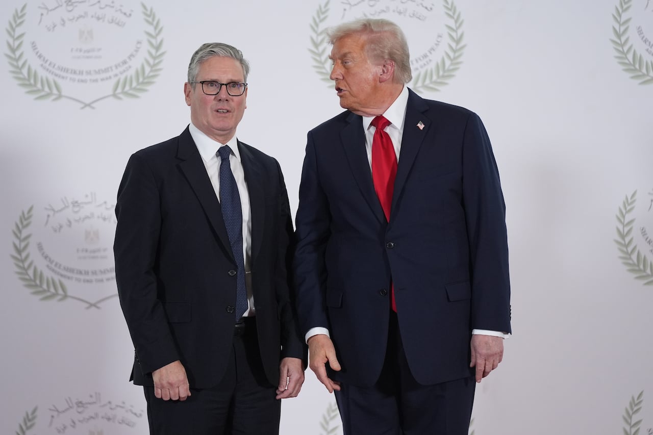 President Donald Trump speaks to British Prime Minister Keir Starmer during summit on Gaza in Sharm El Sheikh, Egypt in 2025.