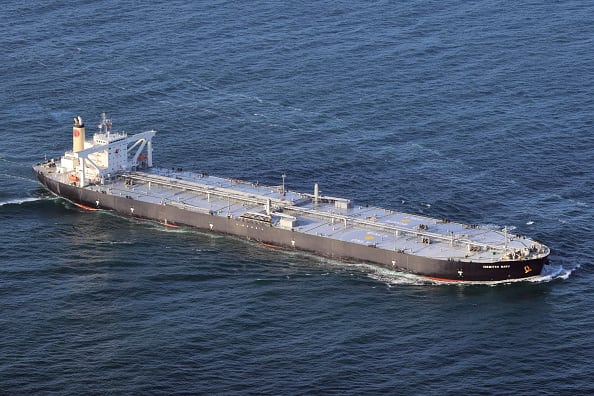 A large cargo ship sails on the sea.