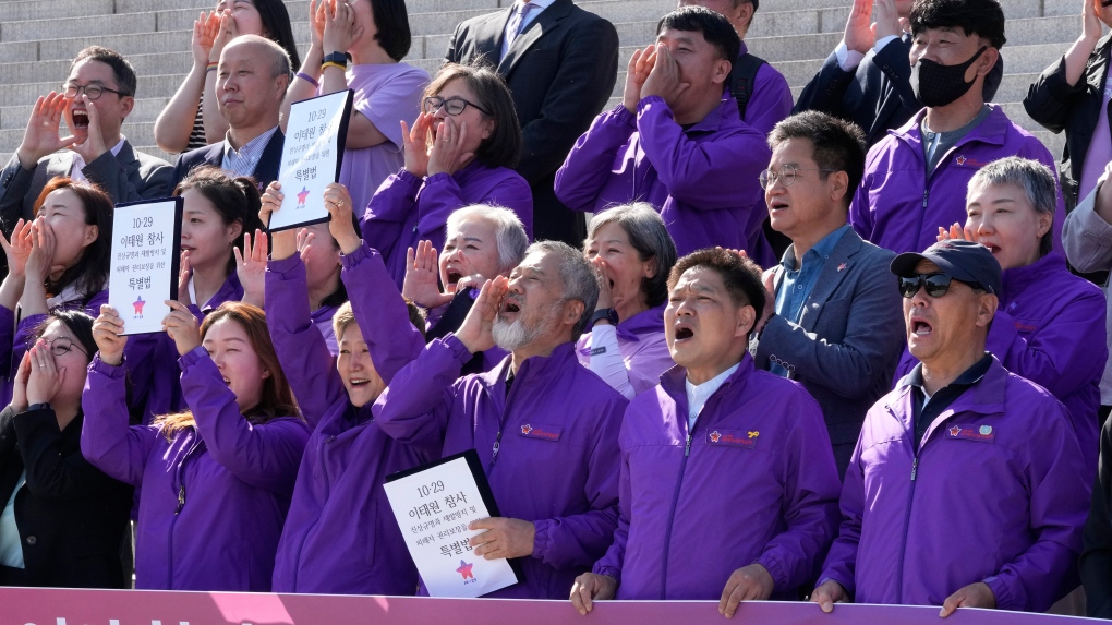 Bereaved family members of the victims of the Halloween crush in 2022 and opposition lawmakers shout during a press conference at the National Assembly in Seoul, South Korea, Thursday, May 2, 2024. (AP Photo/Ahn Young-joon)