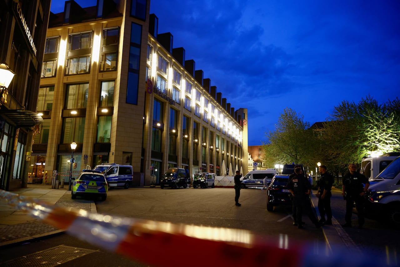 A wide view of a site in Leipzig, Germany, seen at night, where forensic officers investigate after a car struck a group of people.