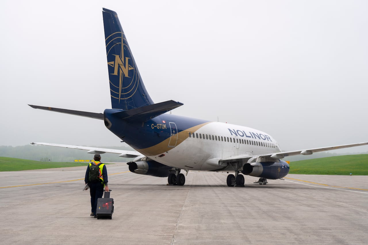 A person walks toward a plane.