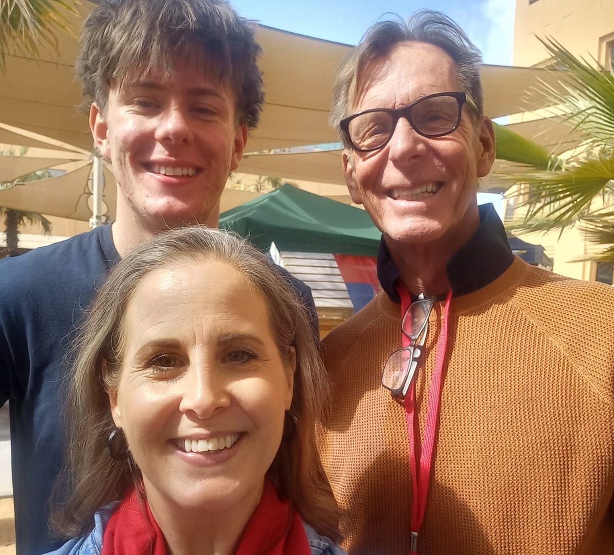 Three people standing and smiling
