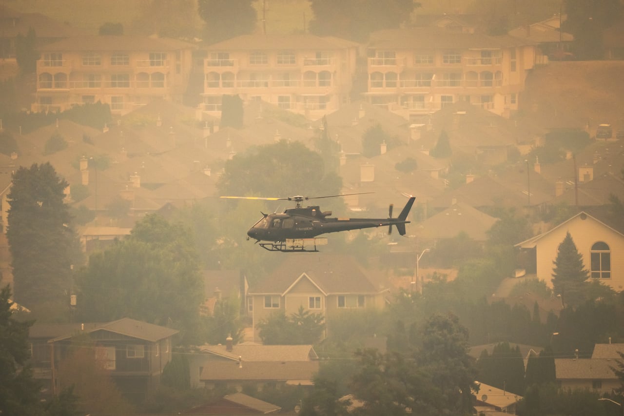 A helicopter is pictured near the Bald Range wildfire in Summerland, British Columbia, on Saturday, Aug. 8, 2026.
