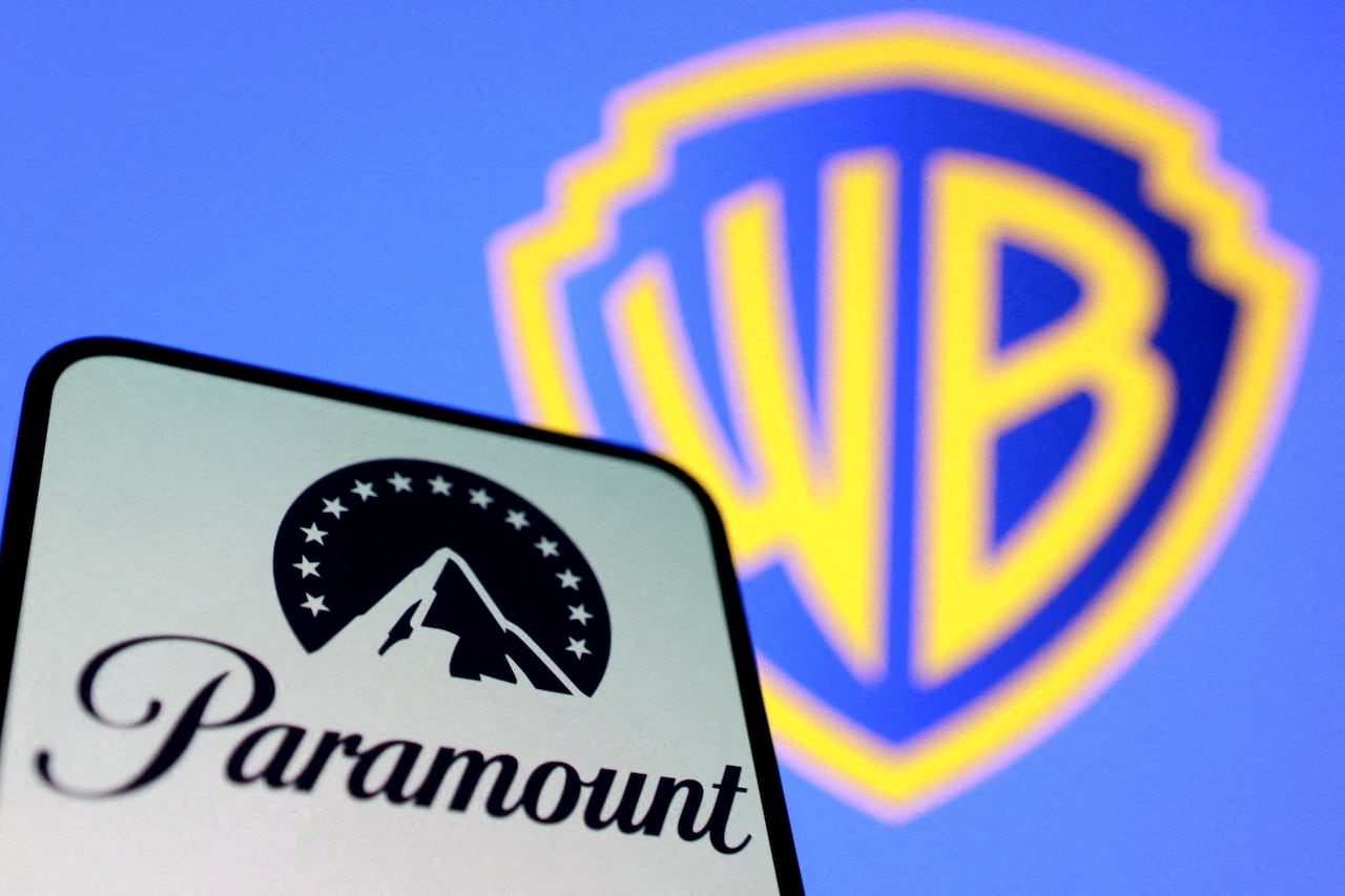 An illustration shows the Paramount mountain logo in black and white to the left, with the yellow Warner Bros logo over blue seen in the background.
