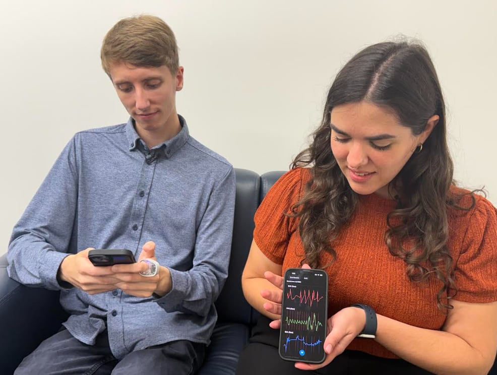 Western University PhD students Samantha Jones and Cole Stevenson demonstrate a study the Body Politics Lab.