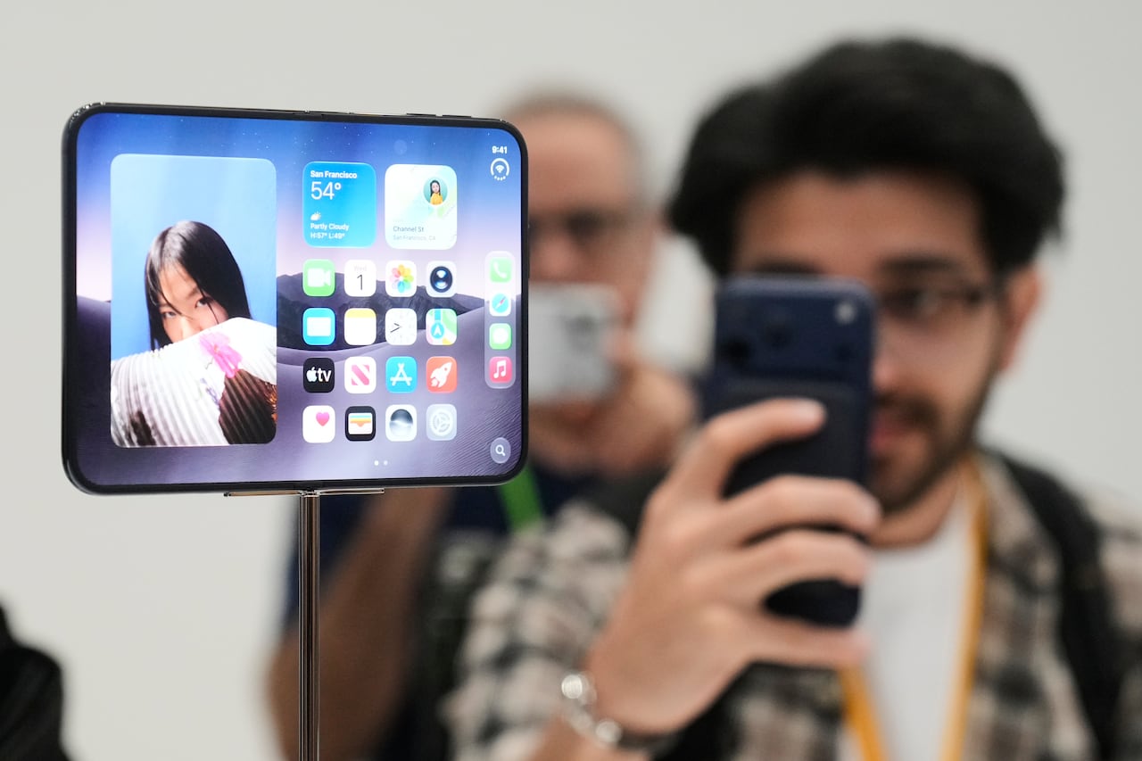 A person takes a photo of a big flat phone