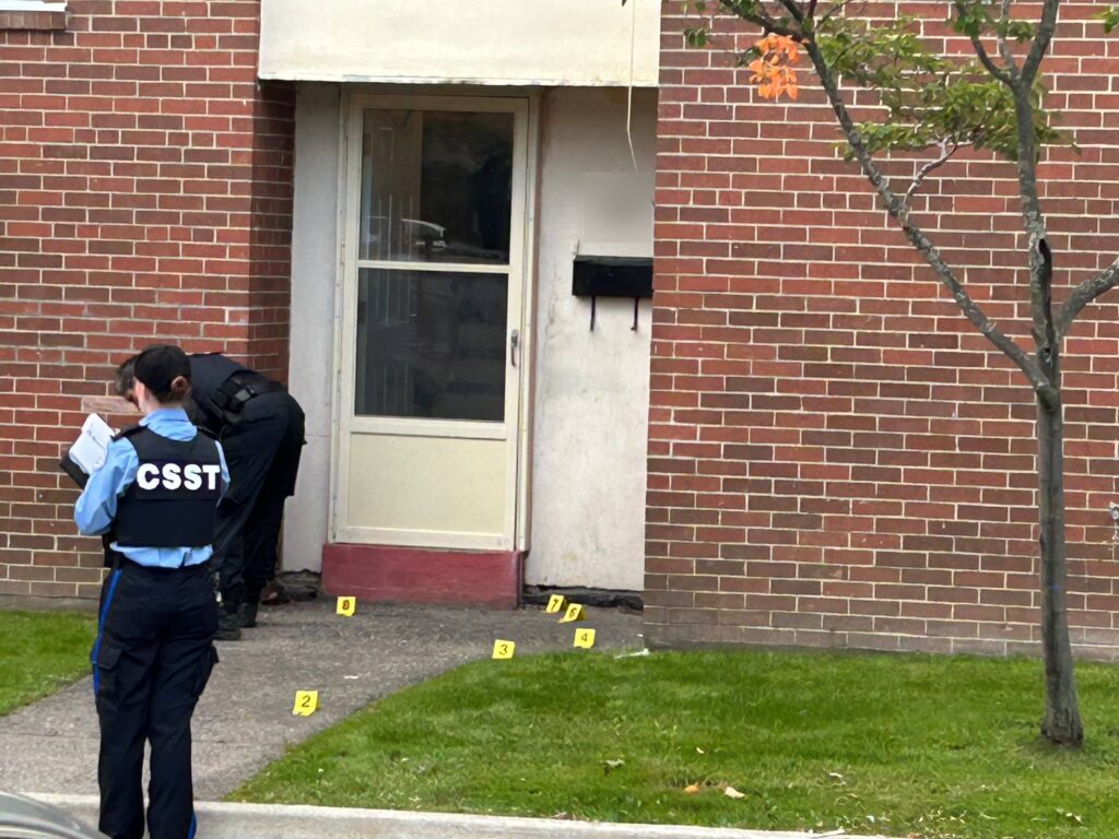 Toronto police evidence markers are seen at a townhouse complex on Danzig Street in Scarborough on Aug. 11, 2026