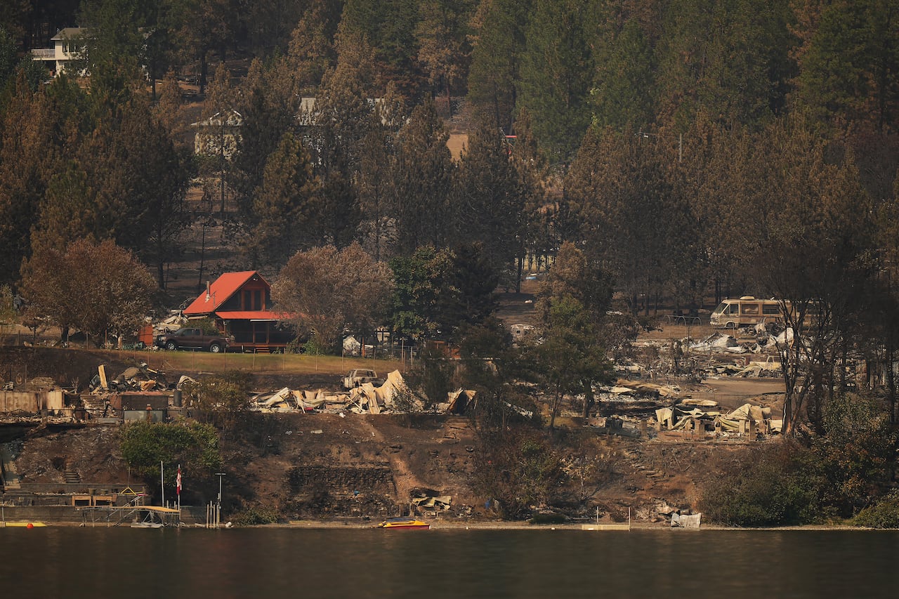 A series of lakeside properties, many of them burned to the ground.