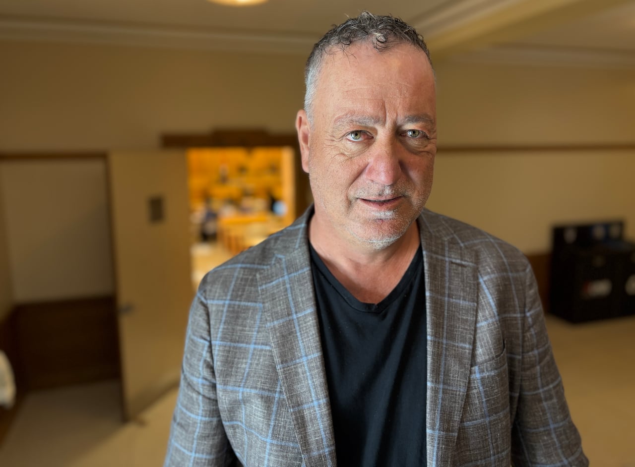 A man with jacket but no tie