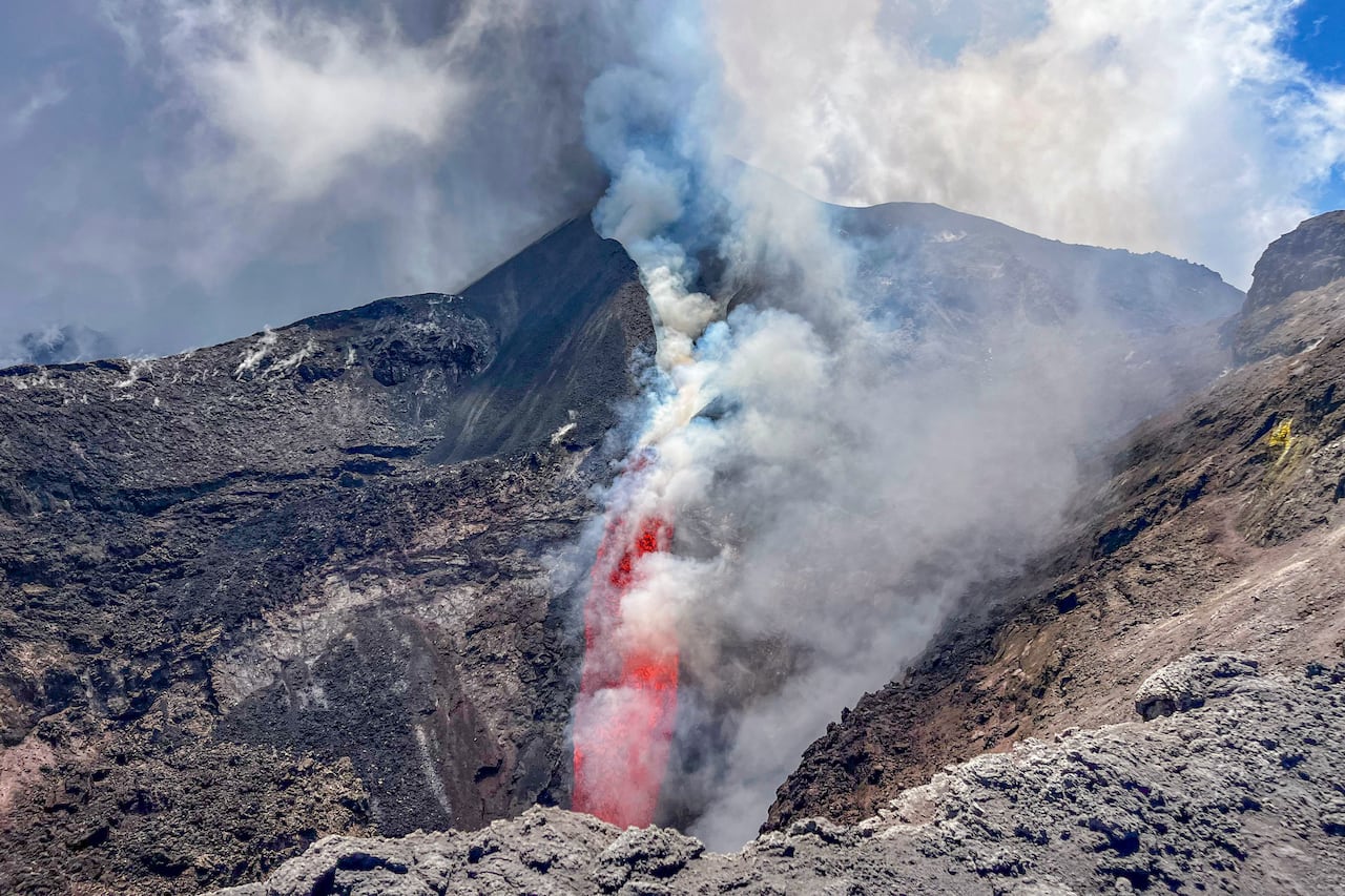 Lava and smoke from a crate of an active volcano.