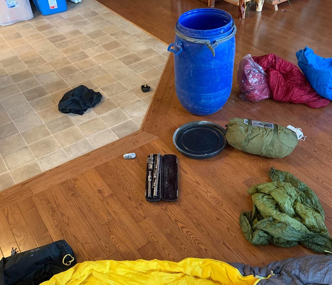 Some camping gear spread out on a floor.