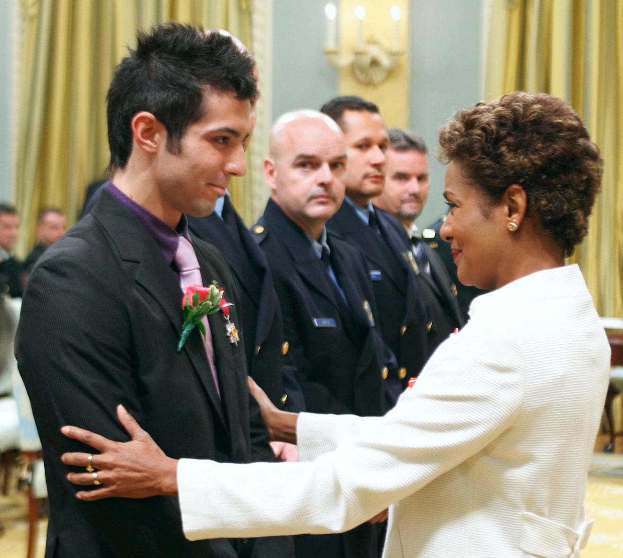 Governor General Michaëlle Jean presents James Santos, far left, the Star of Courage, as Montreal Police constables look on Friday Sept. 19, 2008, during a ceremony at Rideau Hall in Ottawa.
