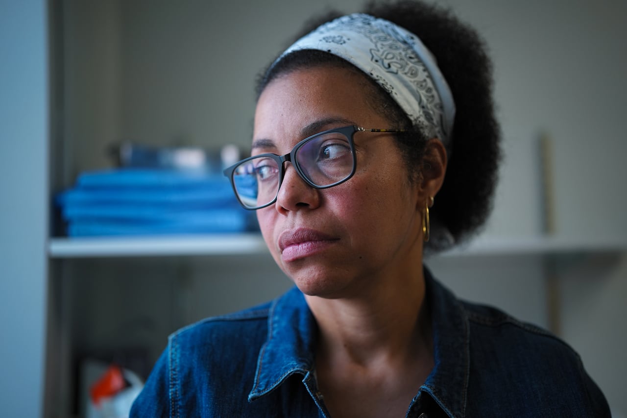 A woman looks to her right.