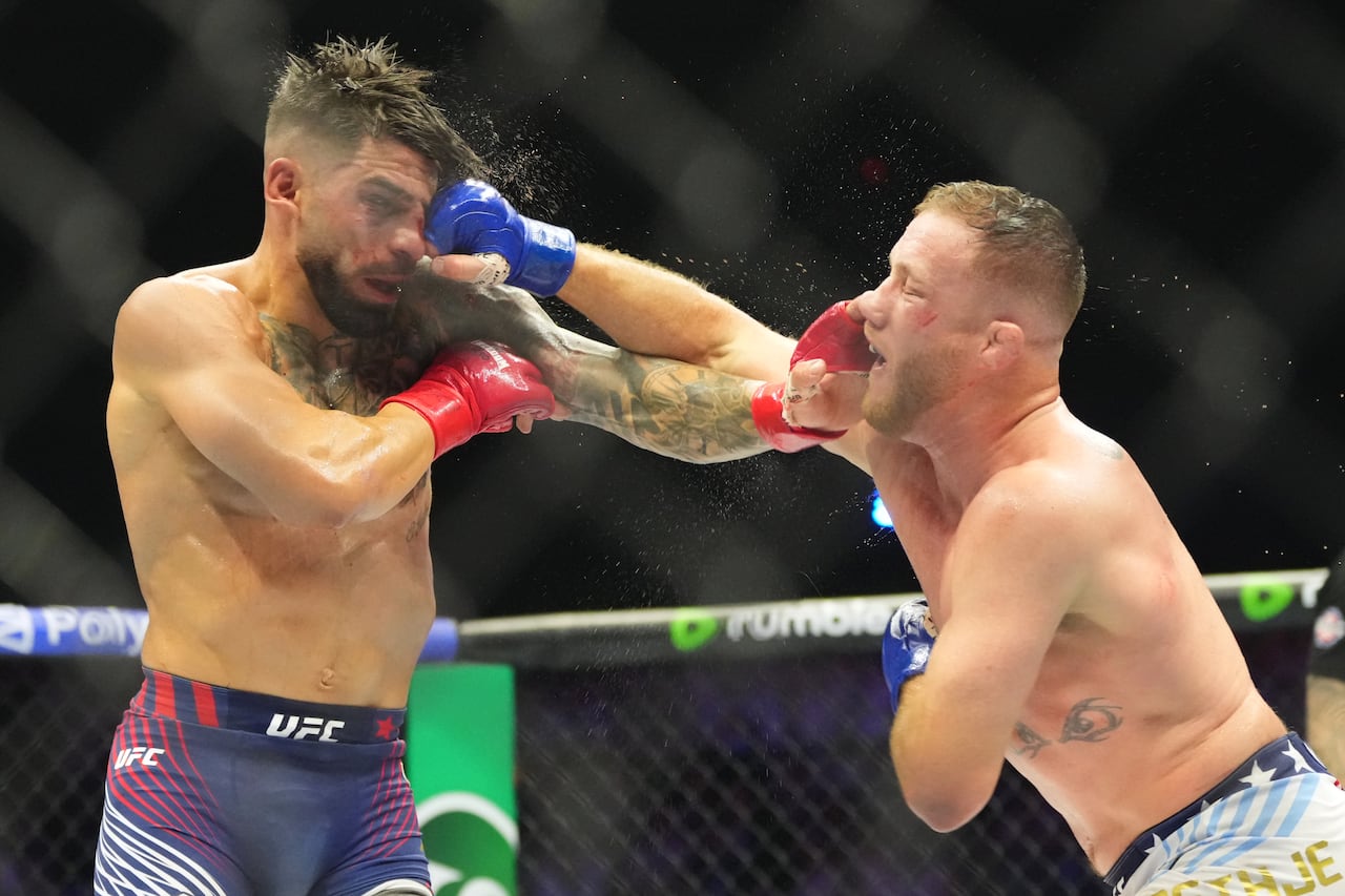 Two men fighting inside a ring.