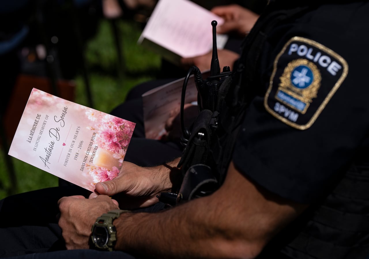 Police officer James Santos holds a program as he attends a ceremony commemorating the 20th anniversary of the shooting at Dawson College, where one person was killed and 19 others wounded, in Montreal on Friday, Sept. 11, 2026.