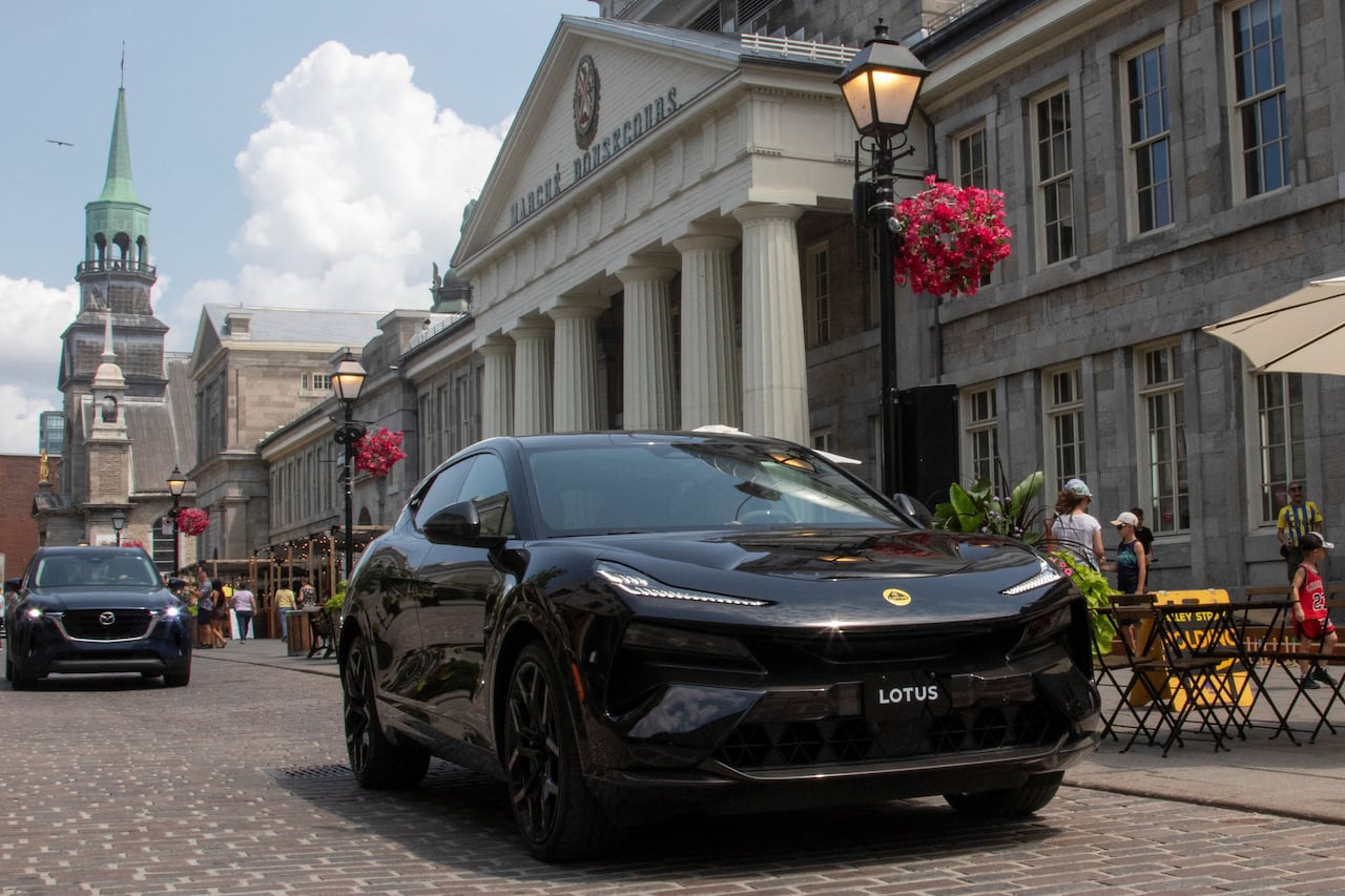 A Lotus Eletre electric vehicle is driven around Old Montreal.