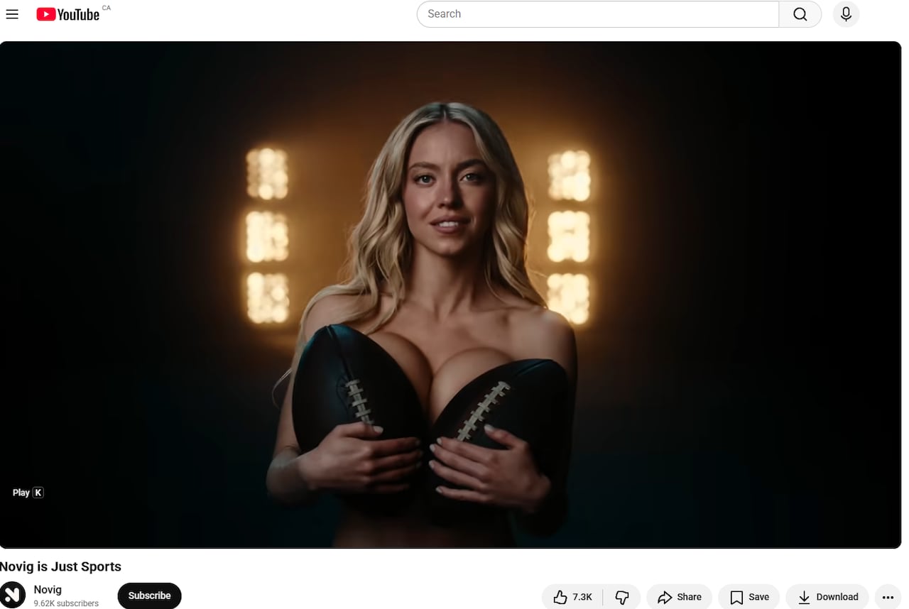 A woman holds a football in front of each breast