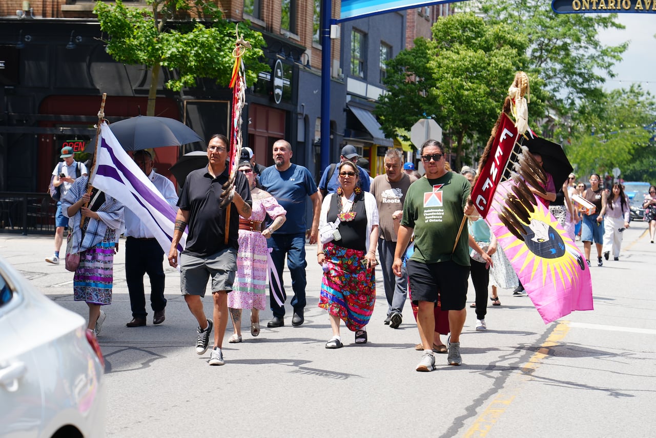 People holding banners march down a street.