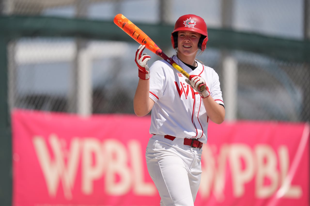 Canadian ballplayer Jaida Lee, holding a bat, while waiting to step up to the plate during a Women's Pro Baseball League exhibition game.