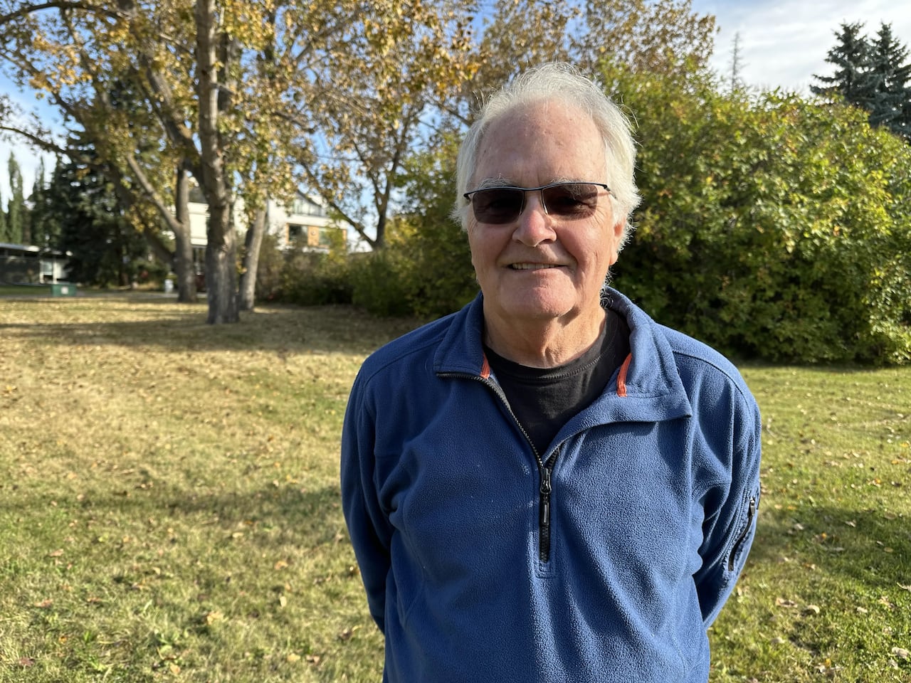 A man stands in a park area.