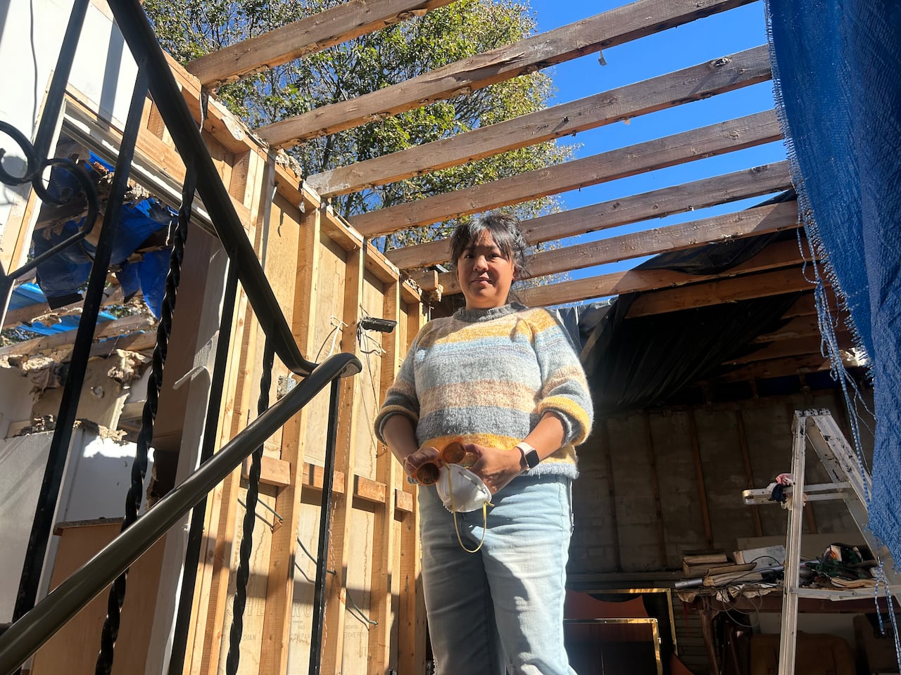 Katie Semple stands in what was once the living room of her uncle's Scarborough home. She says trespassers have done damage, as has the weather.