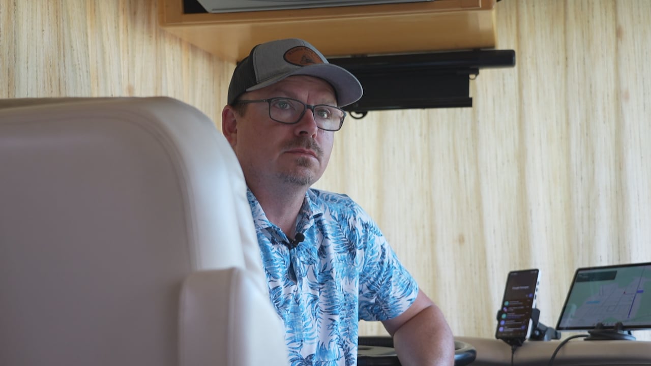 A man sits in a seat in a motorhome.