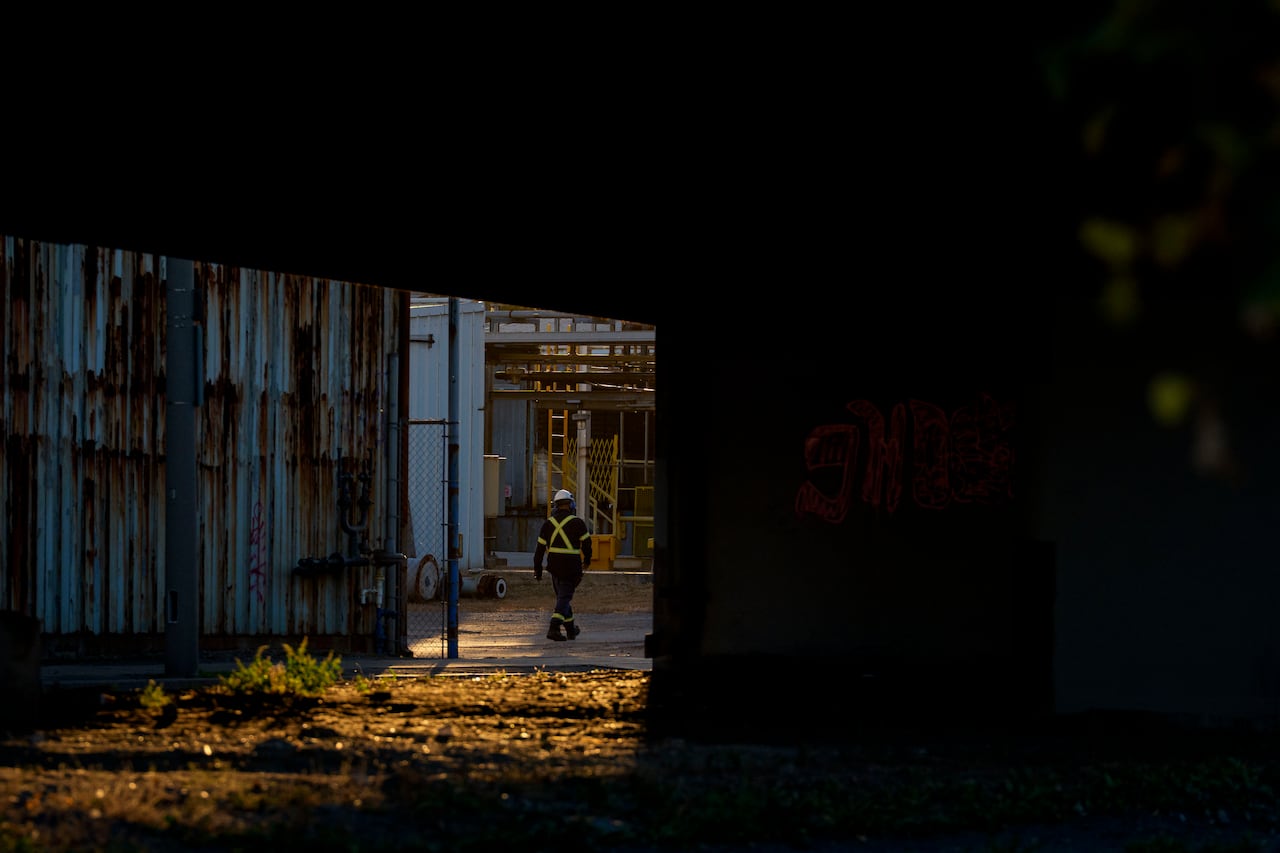 An industrial worker walks near the Stelco Hamilton Works