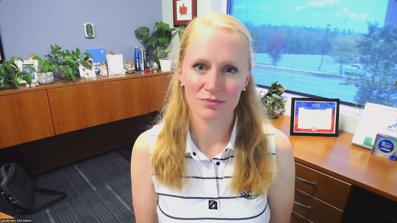 Woman with blond hair wearing striped shirt.