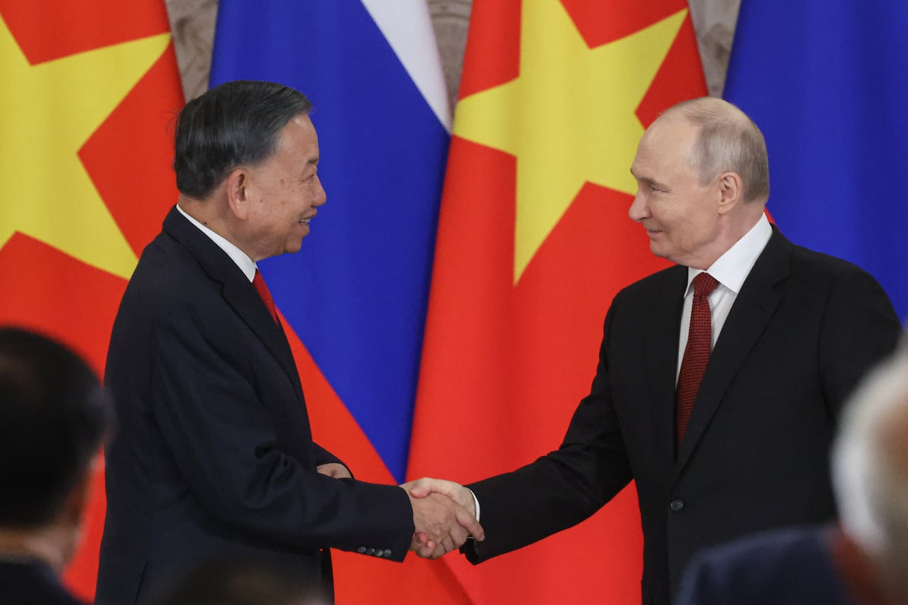 两国领导人握手合影，背景为越南与俄罗斯国旗