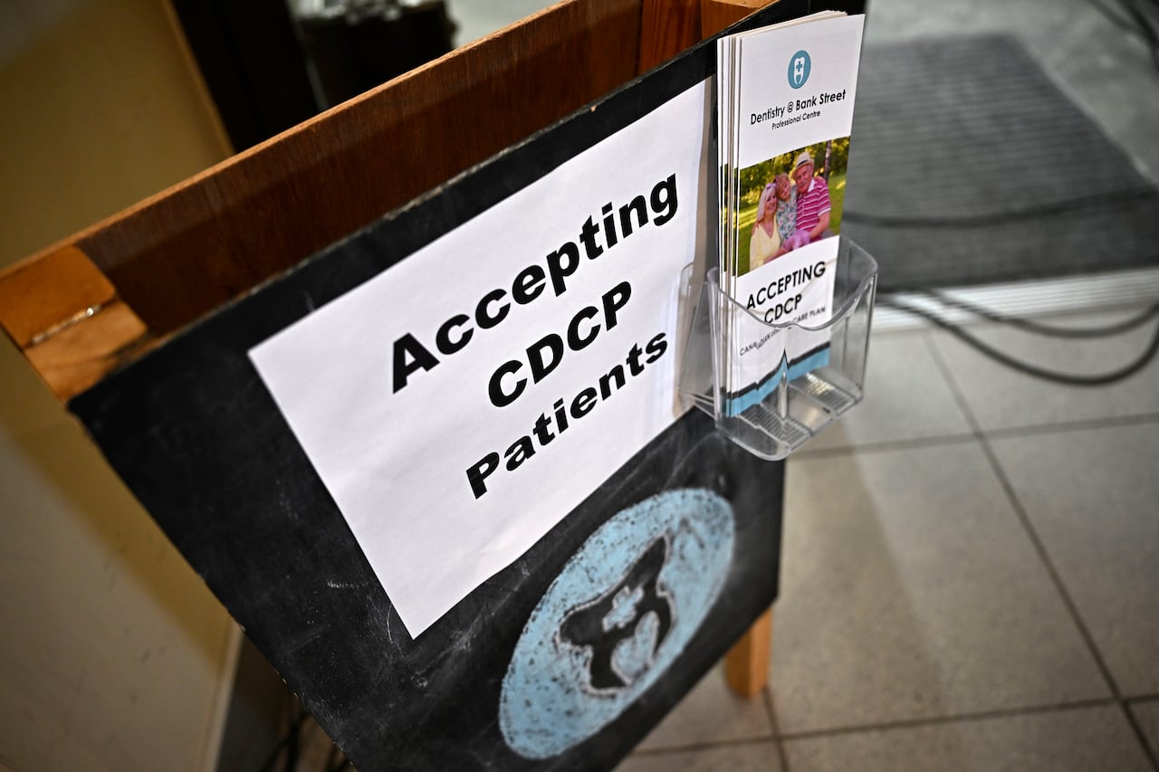 A sign is pictured with brochures on the side.
