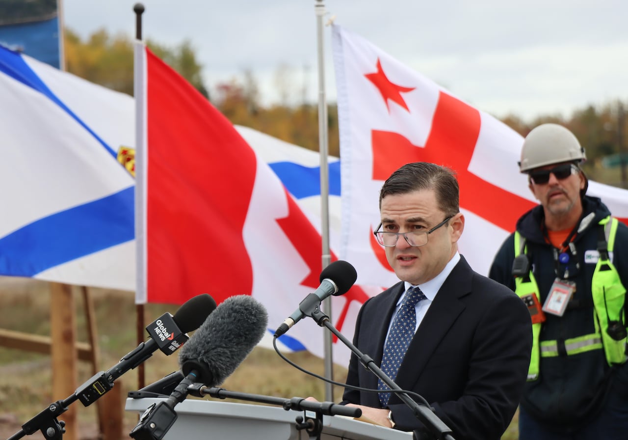 Man with glasses at podium
