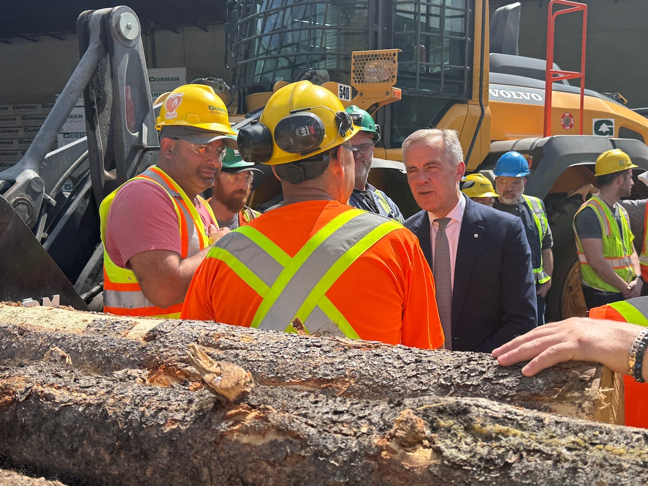 Prime Minister Mark Carney speaks to mill workers