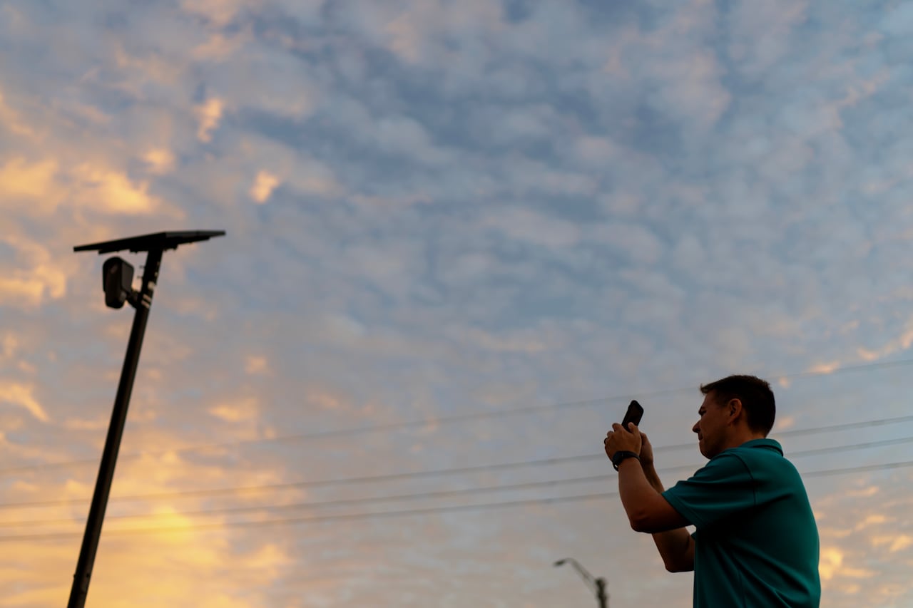 man takes photo of camera