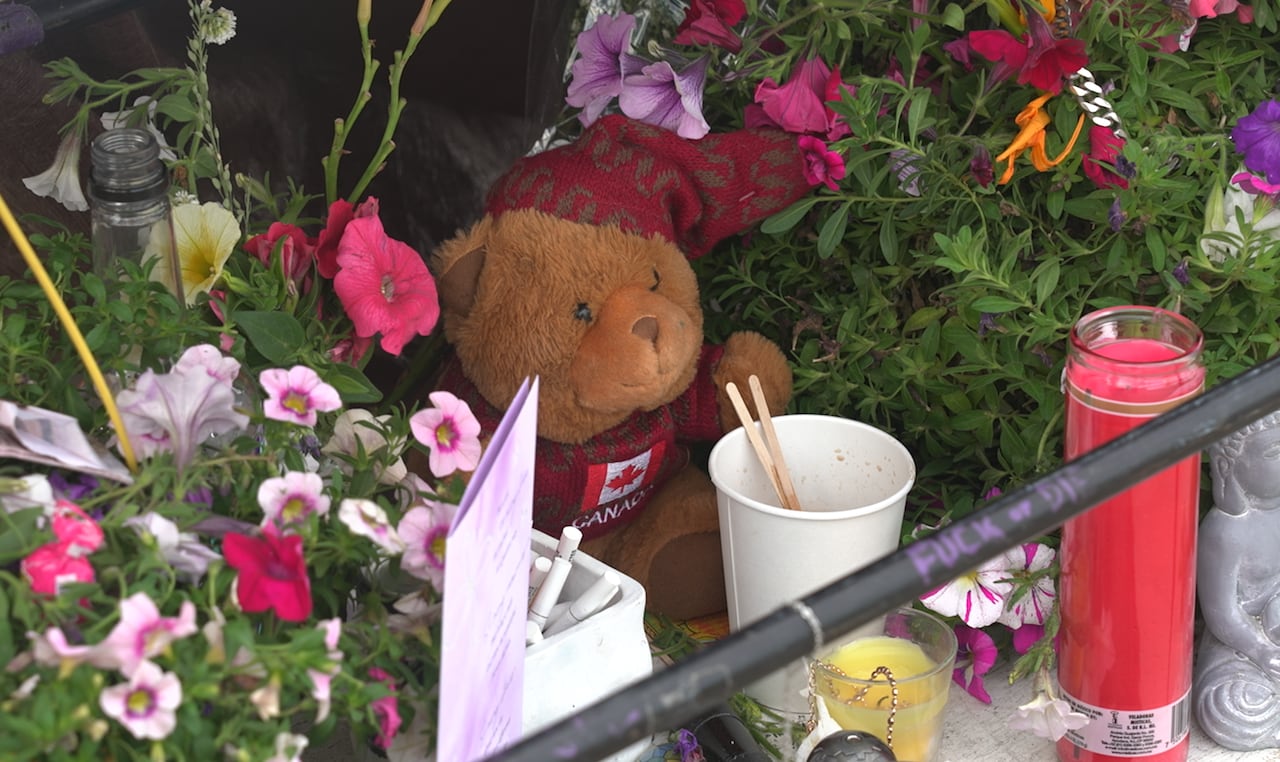 A memorial cart embellished with flowers and candles.