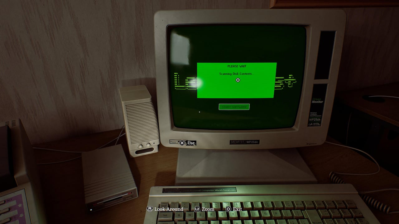 Video game screenshot of an old CRT computer monitor, keyboard and floppy disk reader.