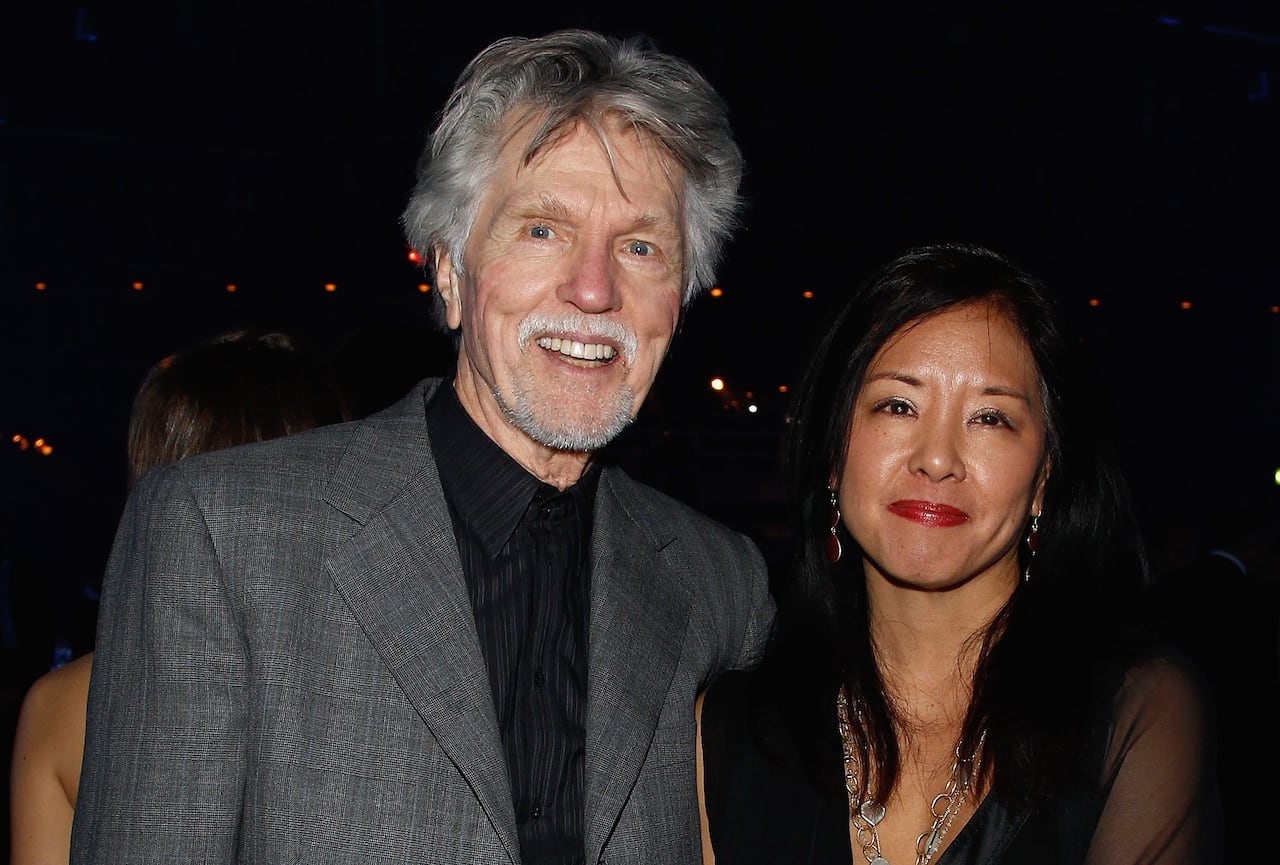 Man and woman pose for camera on red carpet.