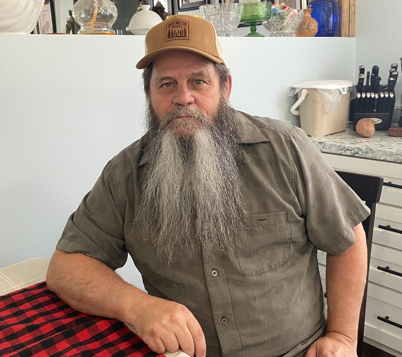 Man with long beard seated at table