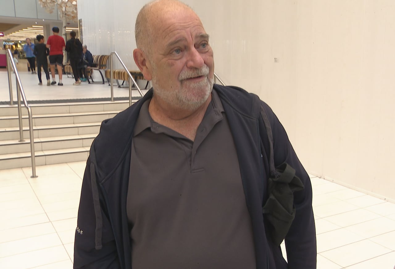 Man in dark polo shirt.