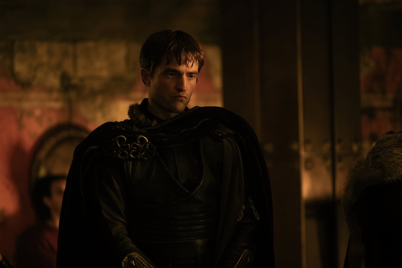 A man in medival clothes scowls