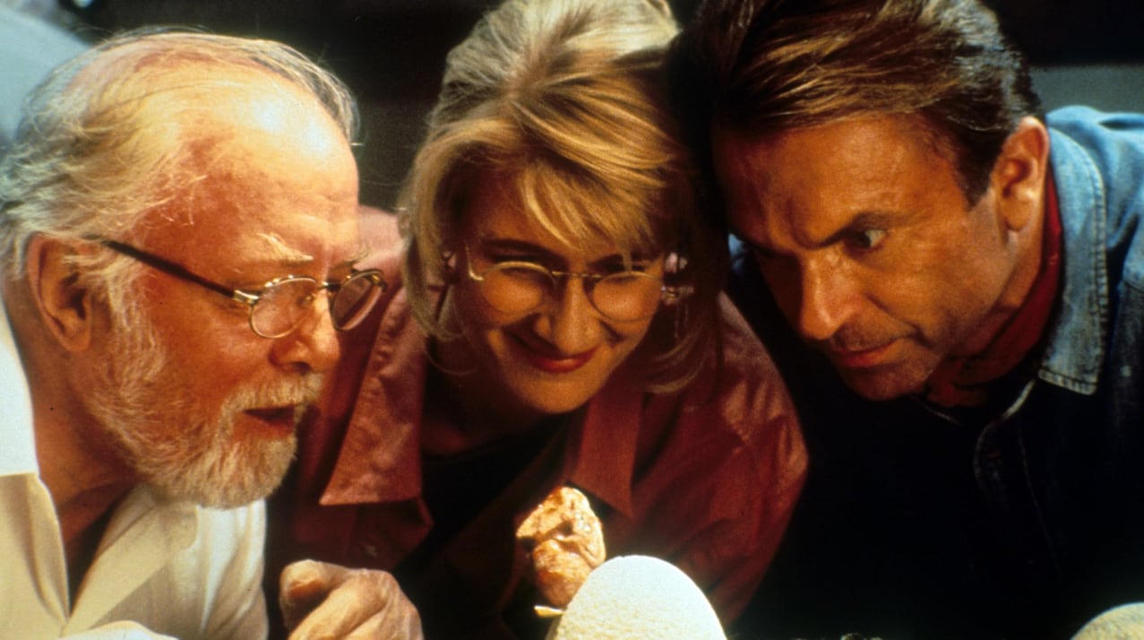 People looking at an egg.