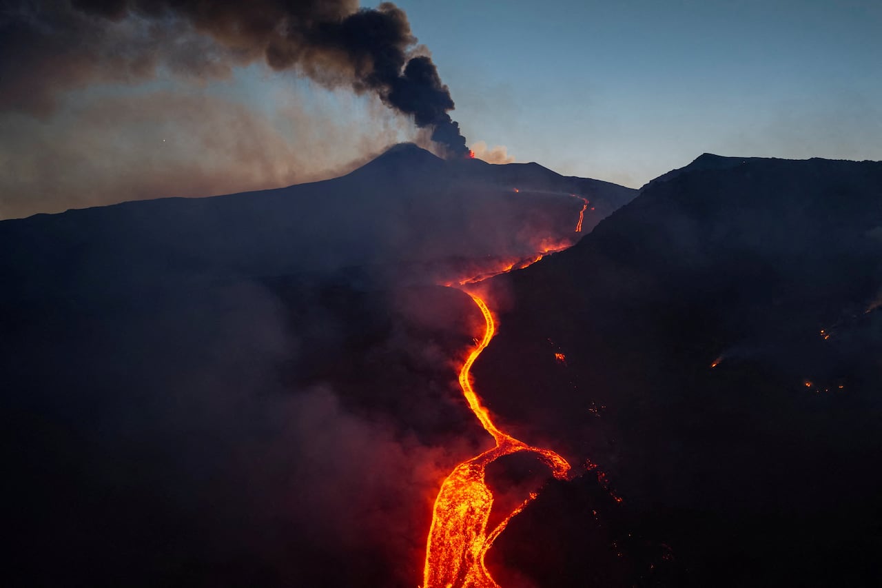 Lava flowin down the slope of an active volcano at dawn.