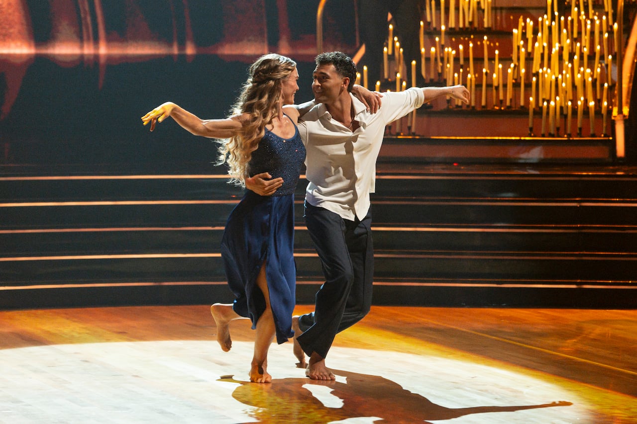 man and woman dance surrounded by candles
