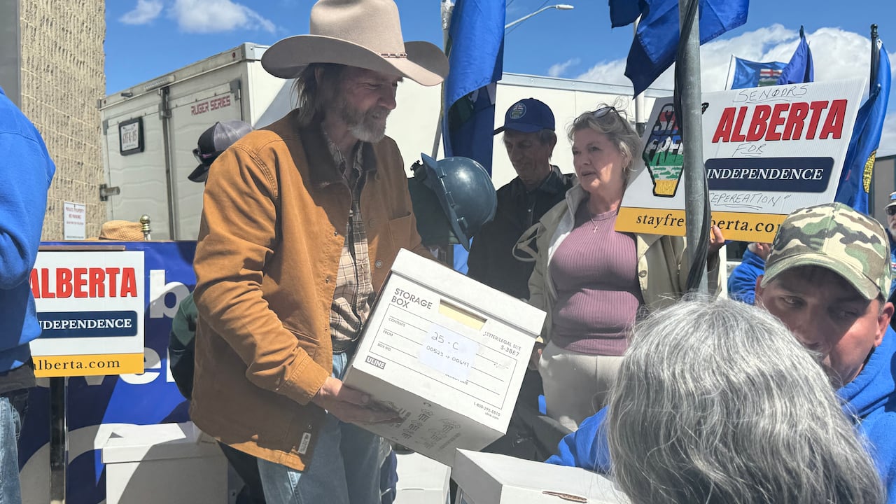 Man in cowboy hat carries legal box