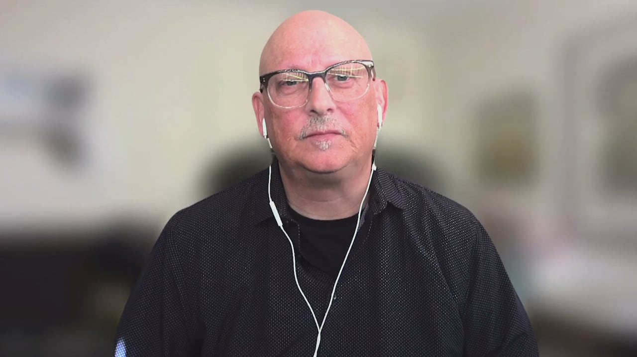 Man with glasses and black shirt