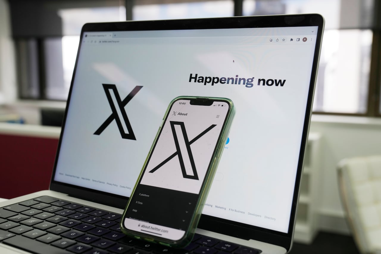 A computer and phone displaying X.