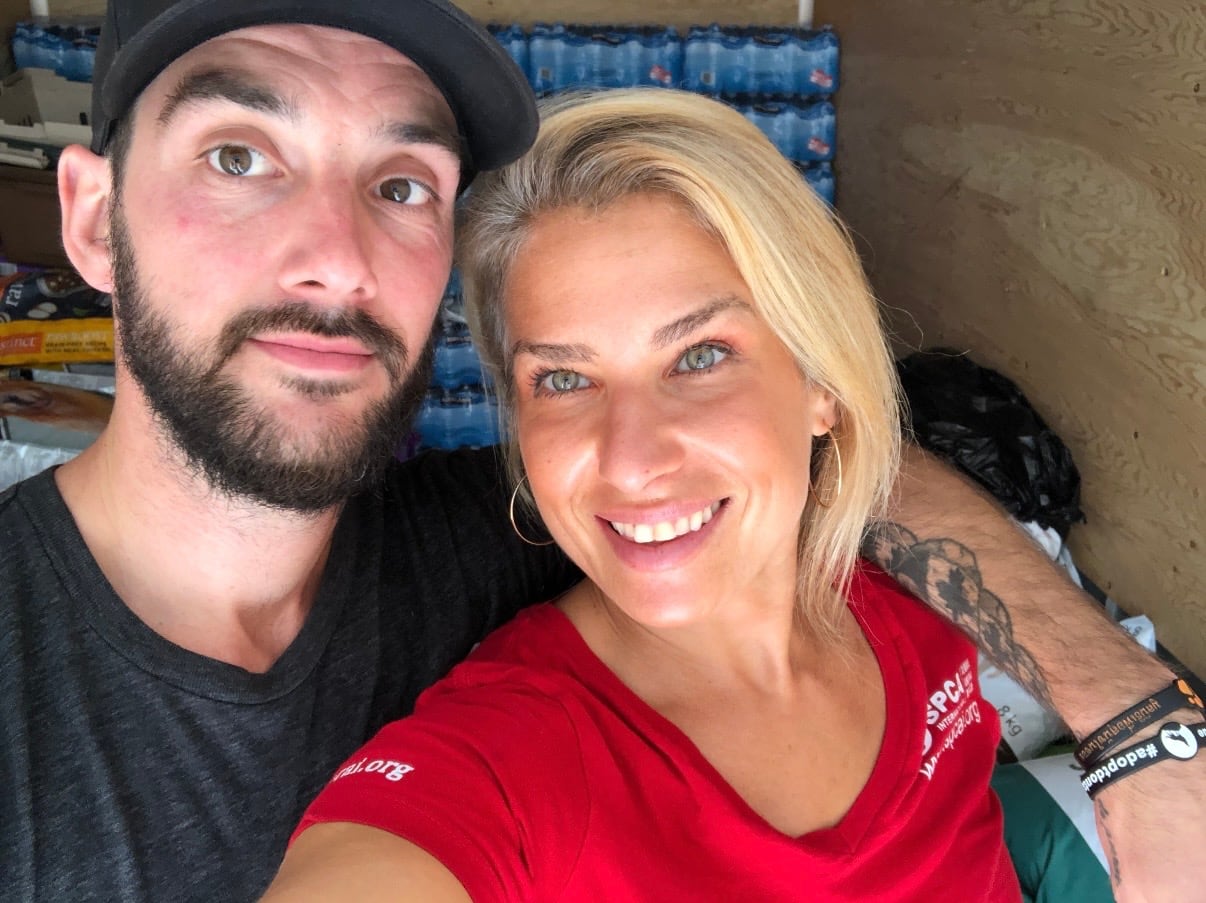 A bearded man and a blond woman smile.