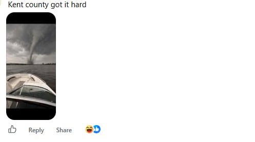 A screenshot of a Facebook comment showing a picture of a large water spout pictured from the front of someone's boat.