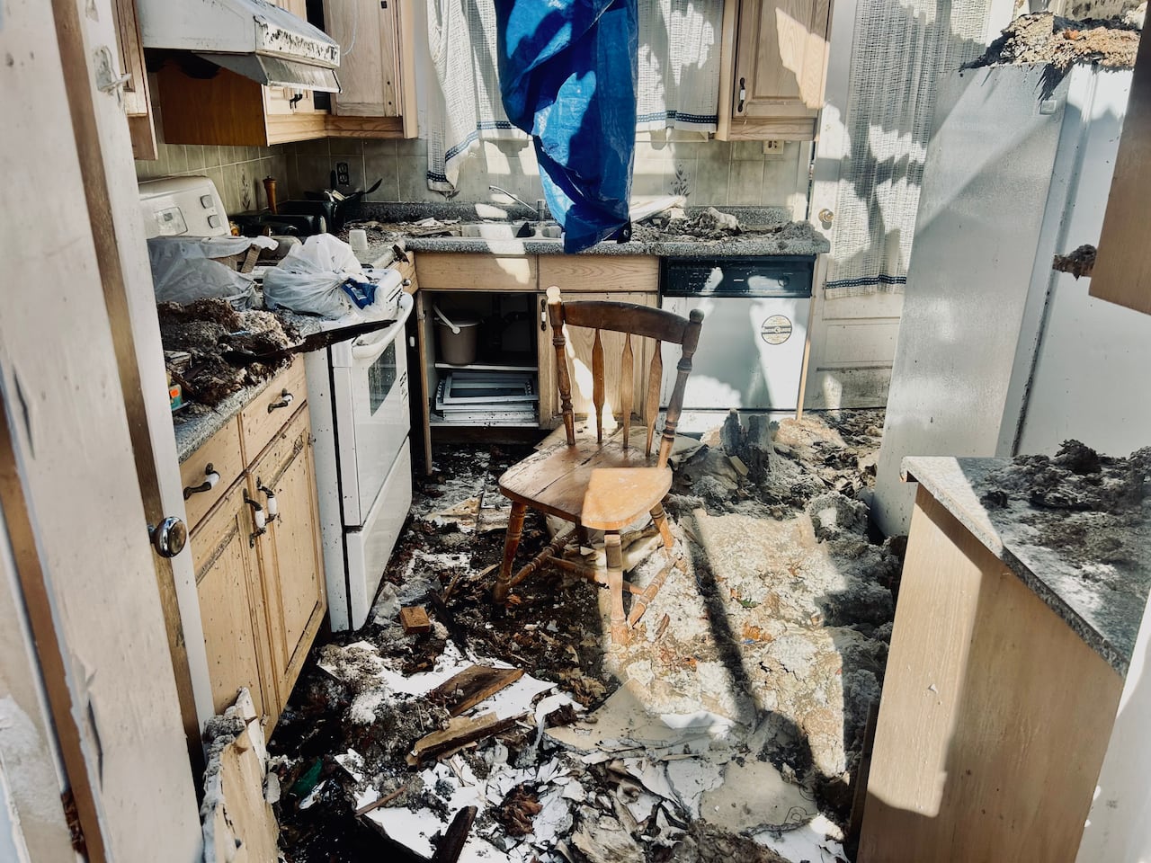 The kitchen of Lawrence Huang's home, four months after contractors left the job site, with the home's roof removed. TD Insurance has said it will cover the cost of the home's ruined contents, but not the structural damage.