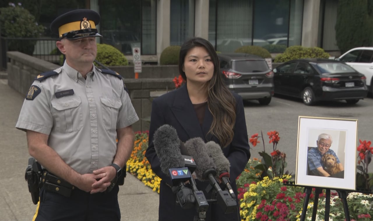 Burnaby RCMP Cpl. Mike Kalang and Sgt. Freda Fong of IHIT speak to media beside a framed photo of shooting victim Chang Yong Cho.